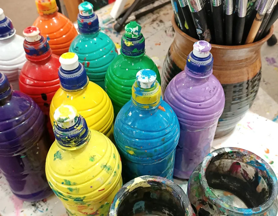 Colourful paints and brushes ready for creative arts therapy sessions